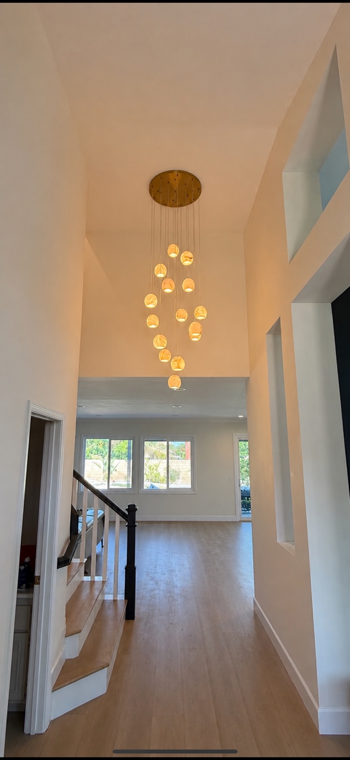 Pendant lighting installed in a high-ceiling entryway
