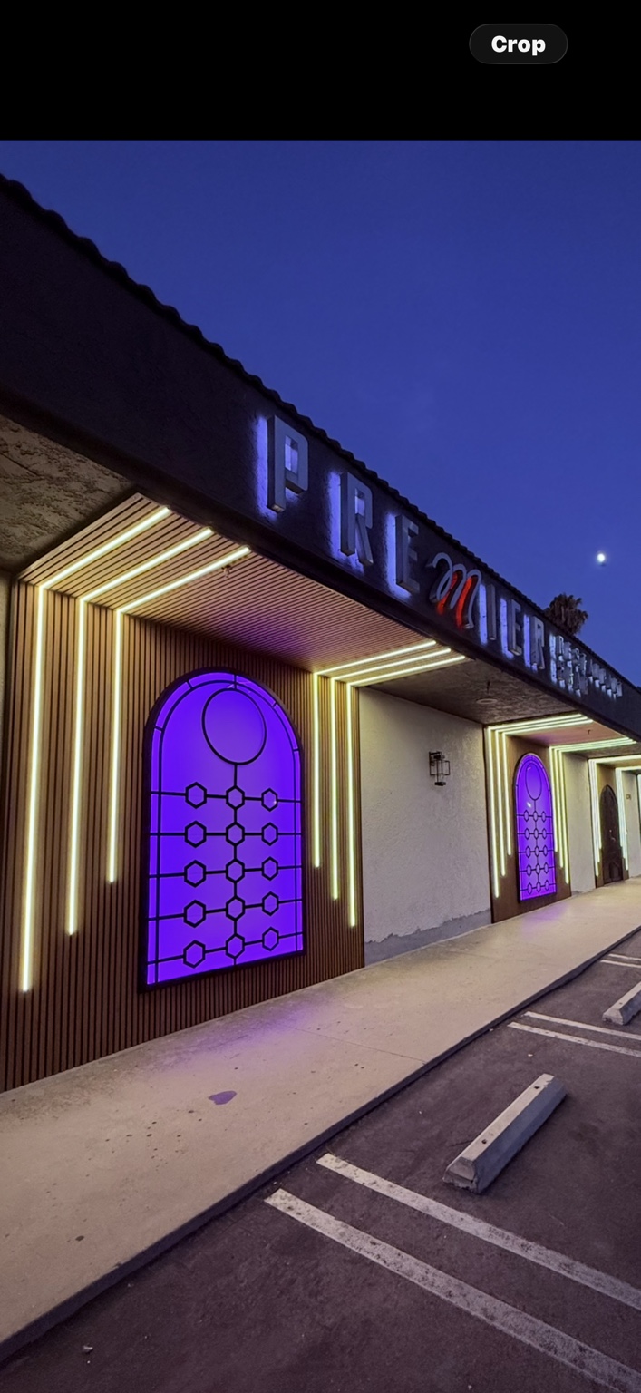 Illuminated storefront with architectural linear lighting at dusk