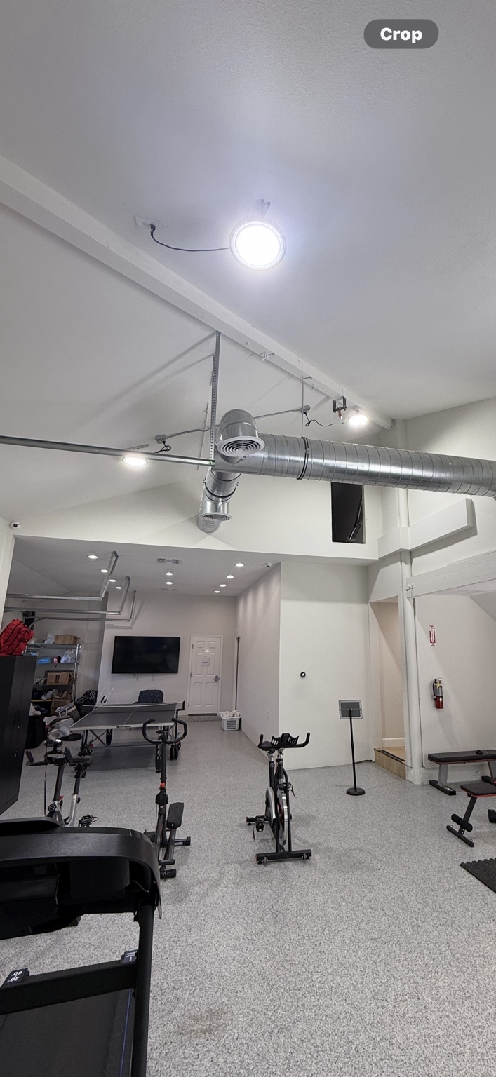 Lighting in a commercial fitness space with exposed ductwork